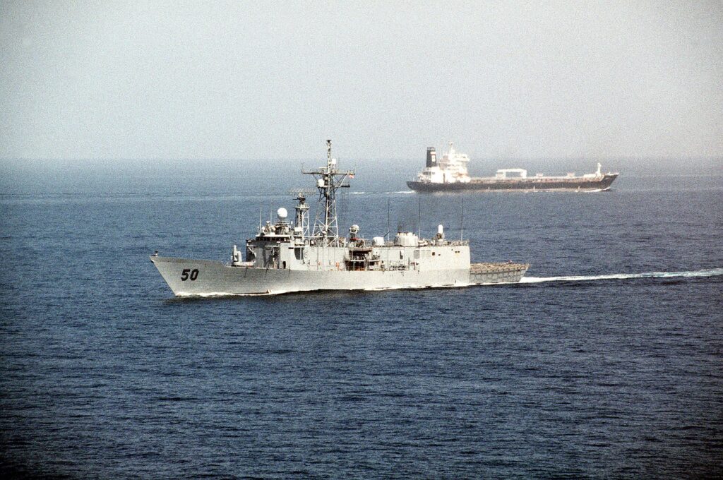 The guided-missile frigate USS Taylor passes an oil tanker after transiting the Strait of Hormuz.