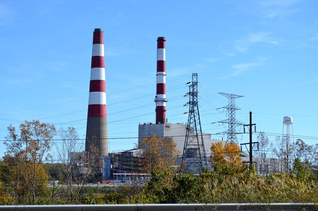 A coal-fired power station against the sky — phasing out fossil fuels is central to closing the gap described in UNEP's Emissions Gap Report 2026