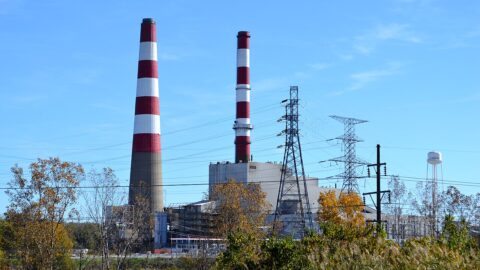 A coal-fired power station against the sky — phasing out fossil fuels is central to closing the gap described in UNEP's Emissions Gap Report 2026