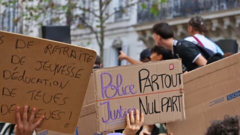 Students holding protest signs during a Paris demonstration in October 2026