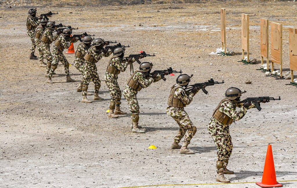 Nigerian Army soldiers in uniform during a live-fire training exercise.