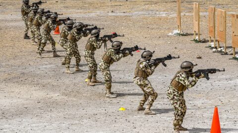 Nigerian Army soldiers in uniform during a live-fire training exercise.