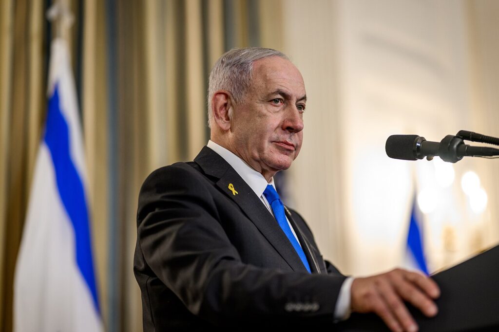 Israeli Prime Minister Benjamin Netanyahu at a White House press conference with an Israeli flag beside him