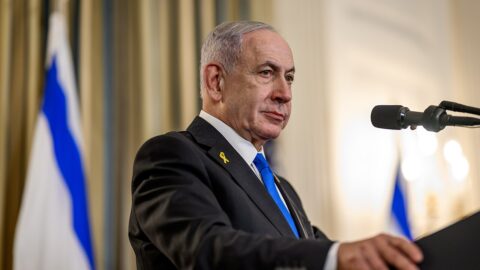 Israeli Prime Minister Benjamin Netanyahu at a White House press conference with an Israeli flag beside him