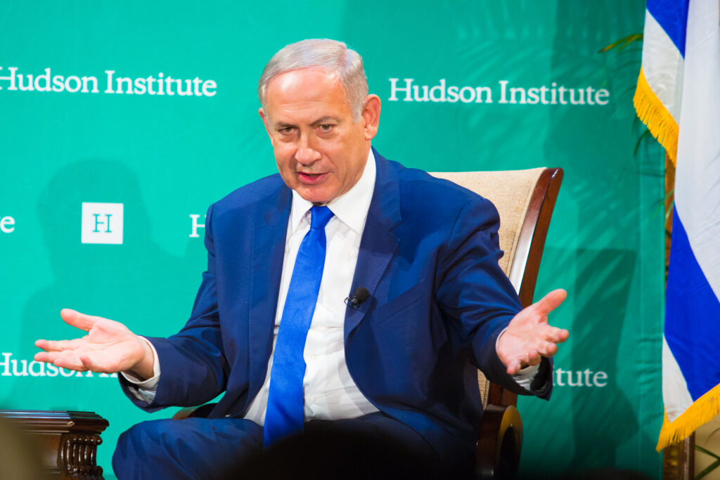 Benjamin Netanyahu gesturing while speaking at a Hudson Institute event