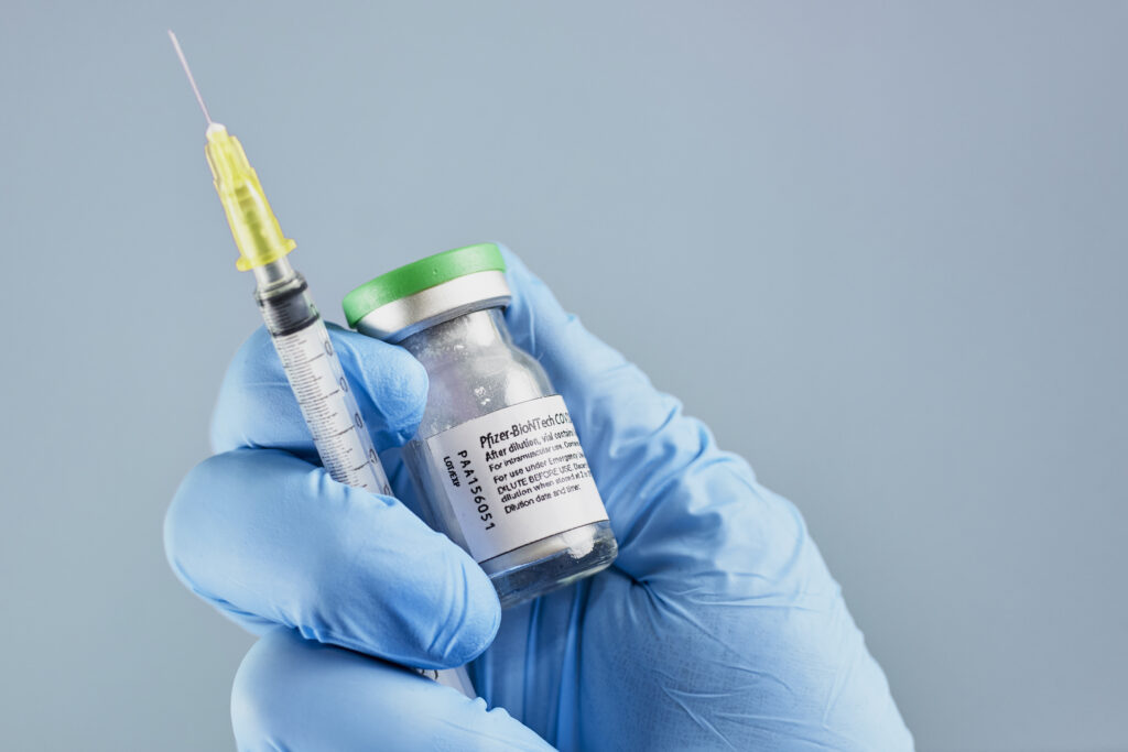 A vaccine vial and syringe in a laboratory.