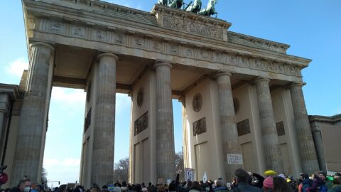 A crowd of protesters gathered in front of the Brandenburg Gate in Berlin.