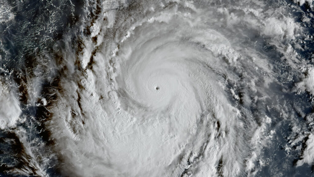 Satellite image of Super Typhoon Champi with its pinhole eye, captured over the western Pacific south of Guam on October 17, 2026