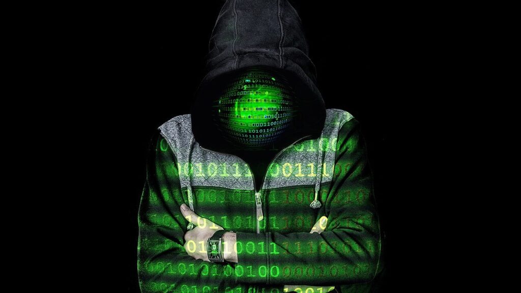 A hooded figure with binary code projected over the face, representing an anonymous dark web user
