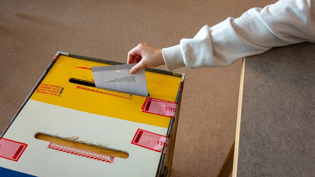 A ballot being dropped into a ballot box