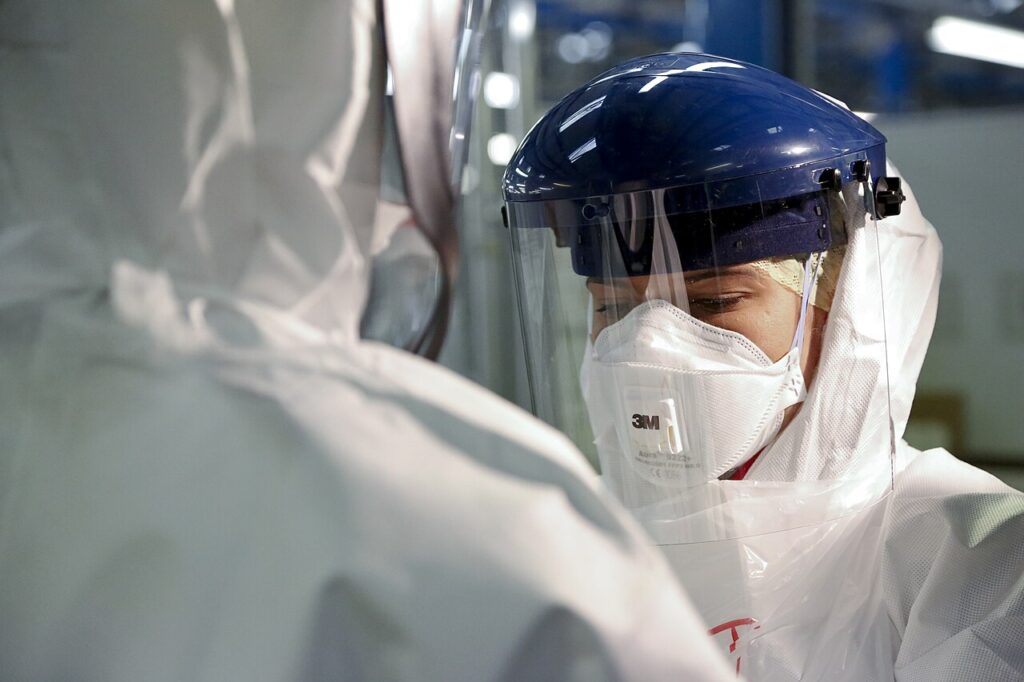 A health worker in full protective equipment, including a face shield and respirator mask, during an Ebola response.
