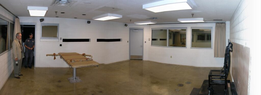 Panoramic view of the execution chamber at Utah State Prison, showing the gurney and witness windows.