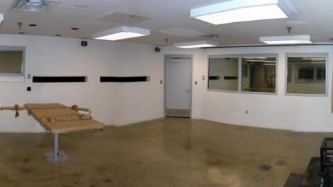 Panoramic view of the execution chamber at Utah State Prison, showing the gurney and witness windows.