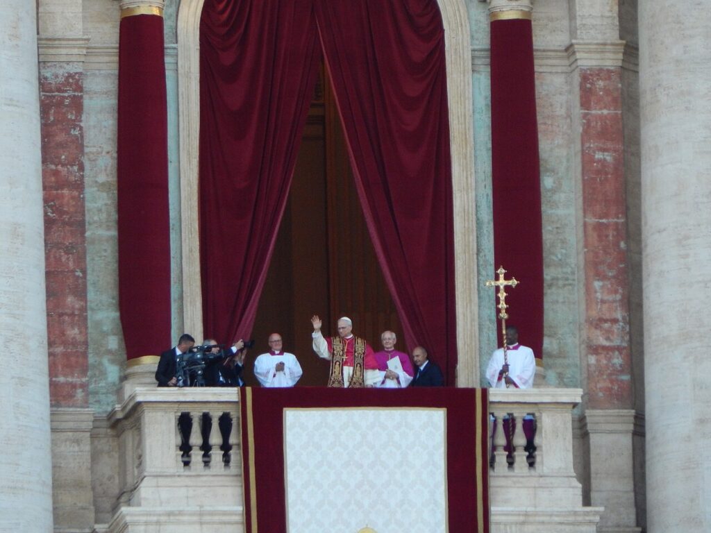Pope Leo XIV waving at the crowd in St. Peter's Square during his first public appearance as pope