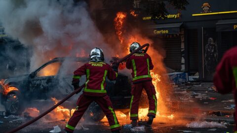 Paris firefighters extinguishing a burning car on a Paris street during the October 17, 2026 riots