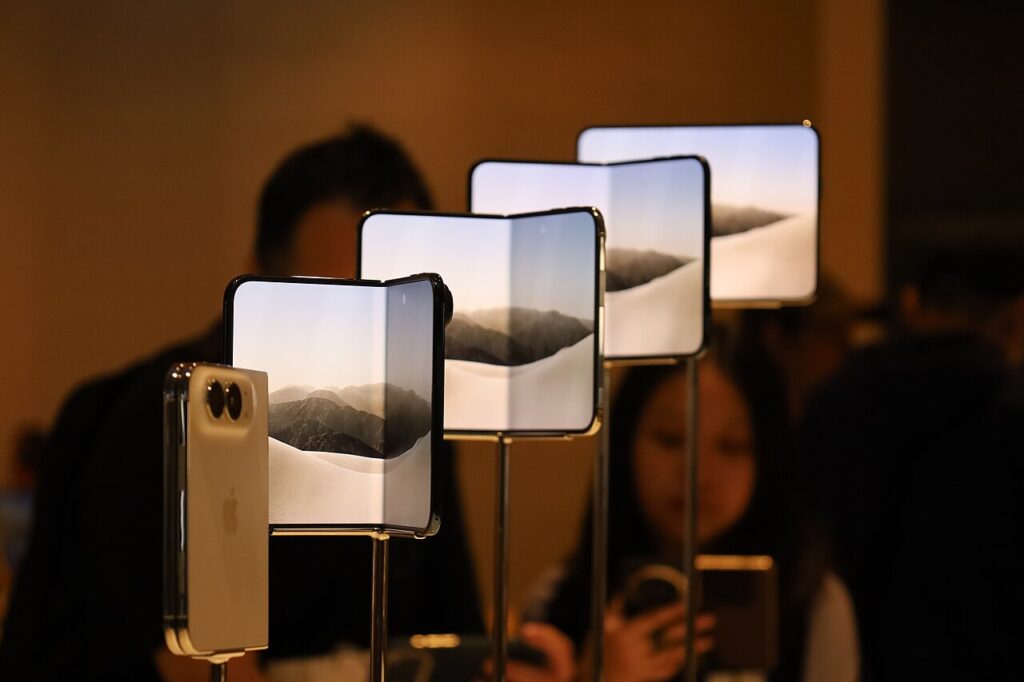 iPhone Duo foldable phones on display stands at the Apple Store TRX in Kuala Lumpur on launch day