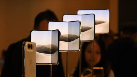 iPhone Duo foldable phones on display stands at the Apple Store TRX in Kuala Lumpur on launch day