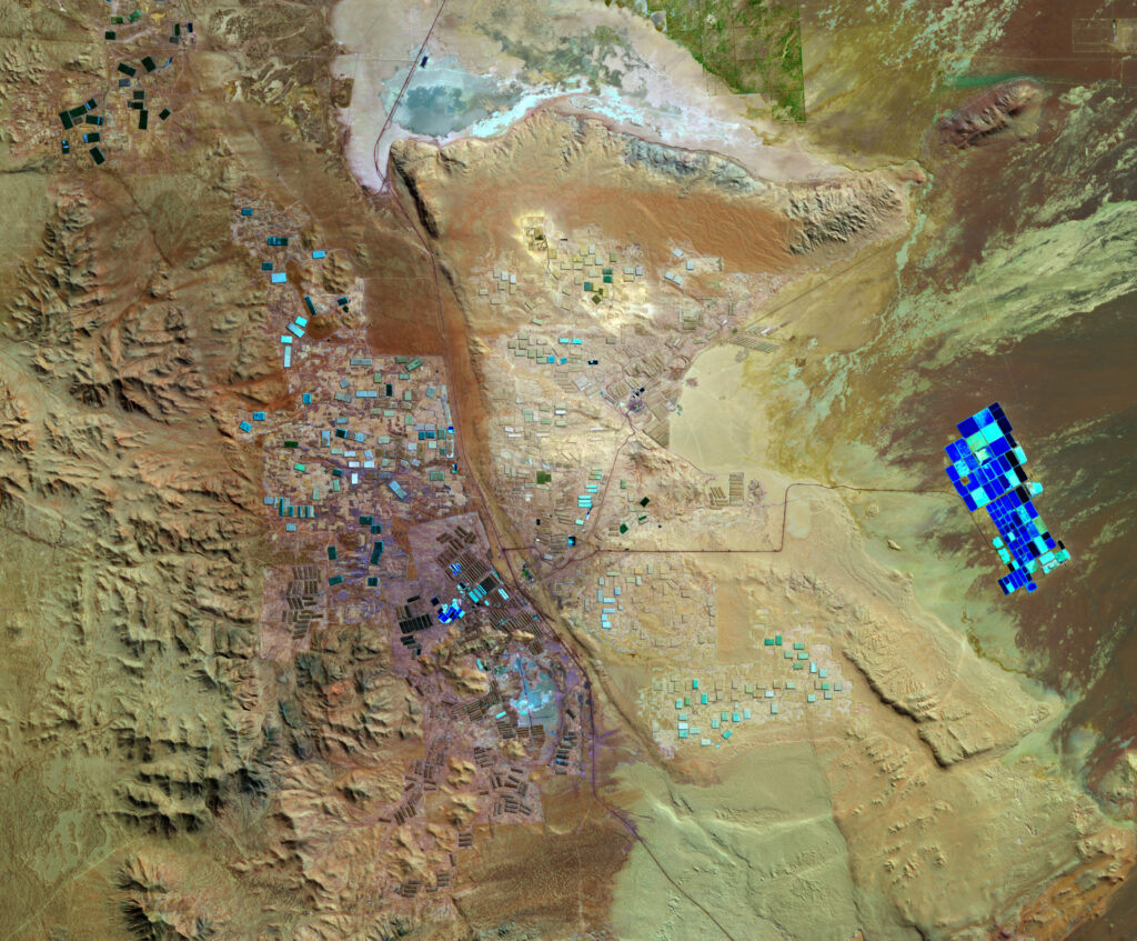 Aerial view of blue lithium brine evaporation ponds in the Atacama Desert