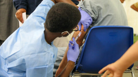 A US Army medic administering a measles vaccine during a mass vaccination drive for Afghan evacuees in Germany