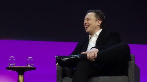 Elon Musk laughing on stage at a TED talk in 2022 (file photo).