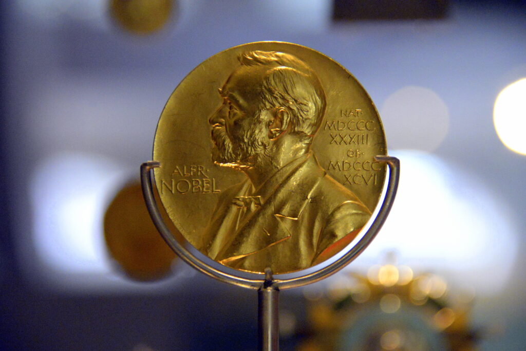 Gold Nobel Prize medal on a display stand
