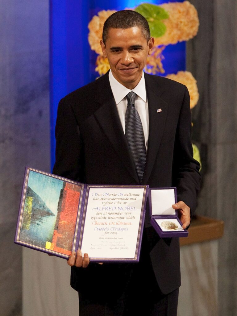 Barack Obama holds his Nobel Peace Prize medal and diploma at the 2009 award ceremony in Oslo City Hall