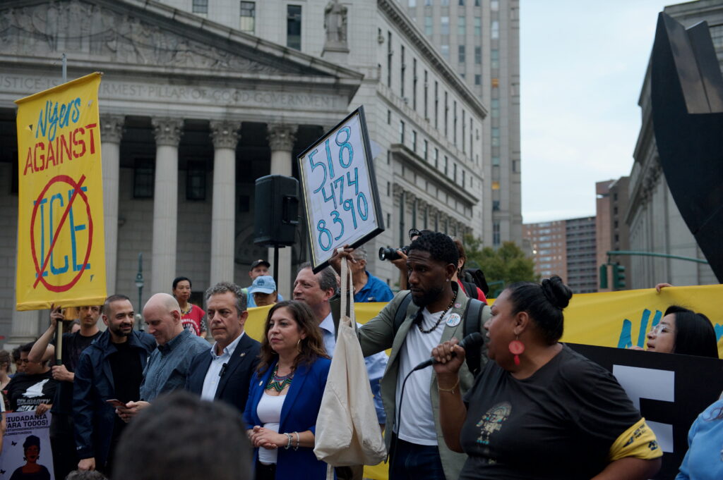 A large crowd of anti-ICE protesters marching with signs through New York City