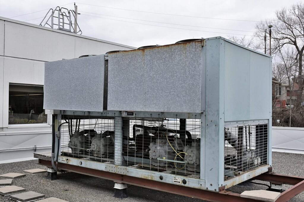An industrial air-cooled liquid chiller on a commercial building rooftop