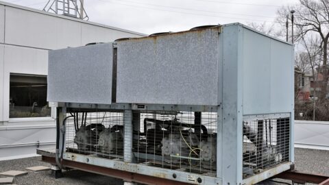 An industrial air-cooled liquid chiller on a commercial building rooftop