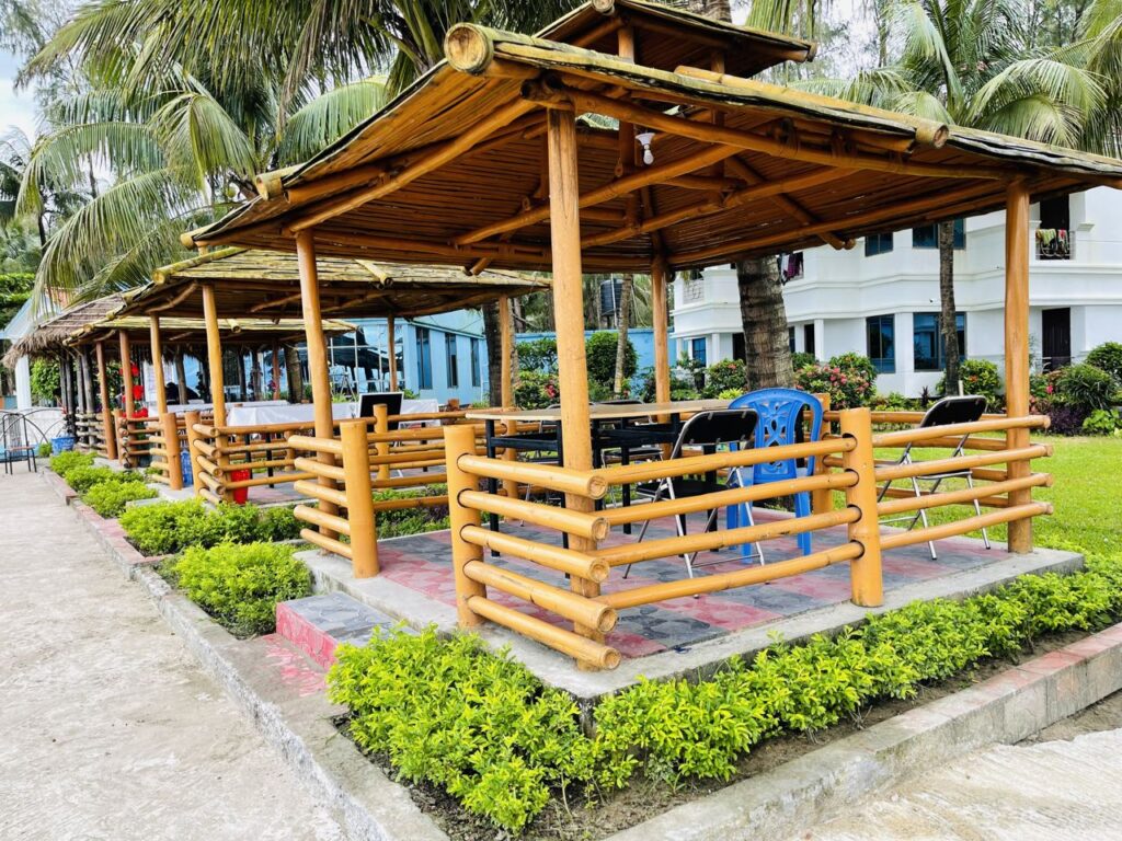 Bamboo-roofed huts and wooden structures at a beach resort in Cox's Bazar, Bangladesh, similar to the bamboo-and-wood construction of Tuptup Resto and Resort destroyed in the Oct 17, 2026 fire.