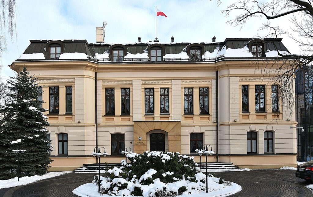 The seat of Poland's Constitutional Tribunal in Warsaw, with the Polish flag flying above the entrance.