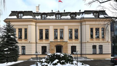The seat of Poland's Constitutional Tribunal in Warsaw, with the Polish flag flying above the entrance.