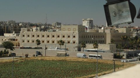 The walled compound of the U.S. Embassy in Amman, Jordan, with the American flag flying above the main building.