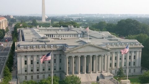 The U.S. Treasury Building in Washington, D.C., with the Washington Monument behind