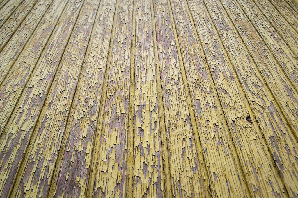 Peeling paint on an old building — deteriorating paint is one of the main sources of lead exposure