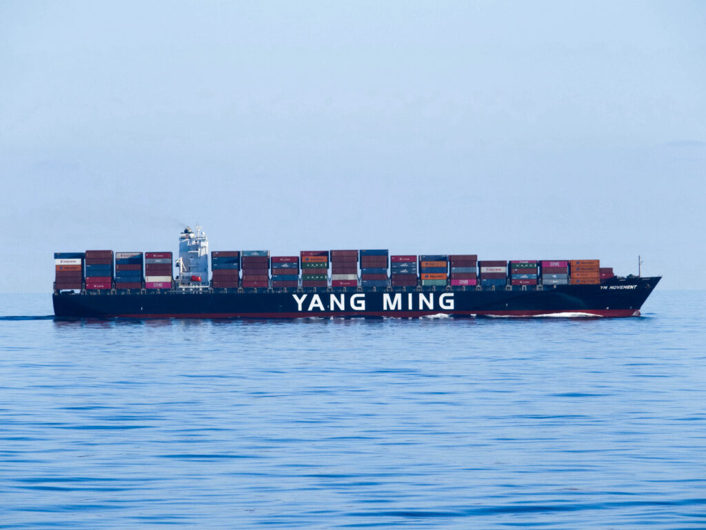 A container ship loaded with containers sailing at sea.