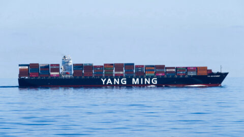A container ship loaded with containers sailing at sea.